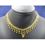 Indian yellow gold necklace of moon and star fringed design with hallow heart charm to centre, total