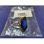9ct yellow gold ring set with a large baguette cut sapphire, shank stamped 375, size S/T