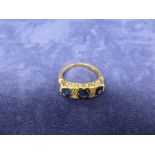 18ct yellow gold ring set with 3 sapphires and 4 diamonds, stamped 18ct size M/N