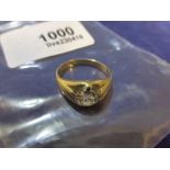 Yellow coloured metal ring inset with a single diamond, approx. 6mm diameter, nibbles around edge of