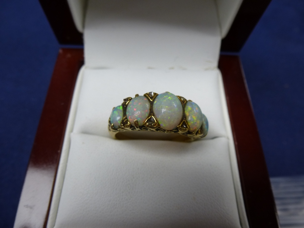 18ct Yellow gold ring set with 5 opals and diamond chips, shank stamped 18 size O