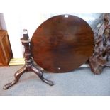 An antique mahogany tripod table having birdcage support on claw and ball feet, some alterations, 85