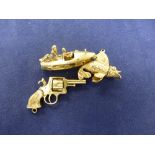 Three 9ct yellow gold charms including a speed boat, hand gun and flying fish, stamped 375, approx