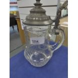 An early 20th century glass tankard having engraved decoration with plated lid