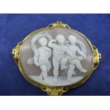 19th Century large oval cameo shell brooch depicting 3 cherubs dancing with yellow coloured metal