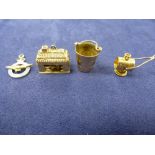 Four 9ct yellow gold charms including a pail, etc approx 9.5g all stamped 375