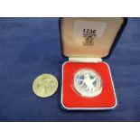 Sterling silver proof coin for the Queens silver jubilee 1977 in case and a similar nickel example