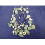 Long white coloured metal necklace with rough cut pale green stone and cultured pearl spacers