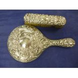 Edwardian Silver backed hand mirror with embossed decoration, Birmingham 1908 and matching clothes