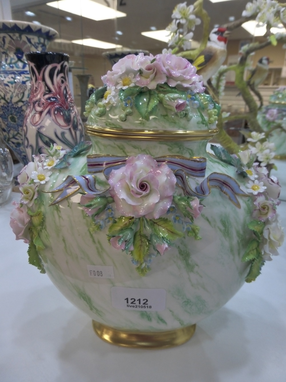 A Lunton porcelain vase and cover with floral encrusted decoration 23cm