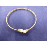 Yellow gold coloured metal and cultured pearl bangle unmarked approx gross weight 6.9g