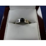 9ct white gold ring set with a black pearl flanked by 2 small diamonds stamped 375 size P