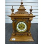 A German Walnut mantle clock having carved decoration, 53 cms