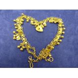 Indian yellow gold necklace of moon and star fringed design with hallow heart charm to centre, total