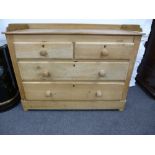 A stripped pine ch having two short and two long drawers