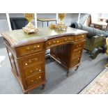 An early 20th century pedal desk having nine drawers, the reverse with cupboards enclosing