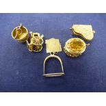 Small collection of yellow coloured metal charms, unmarked, including piano, stirrup, etc gross