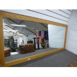 A large contemporary oak wall mirror