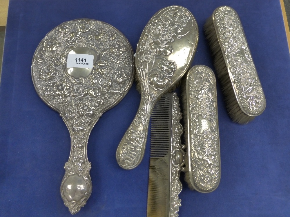 Edwardian silver backed 4 piece dressing table set embossed with cherubs and vines, together with