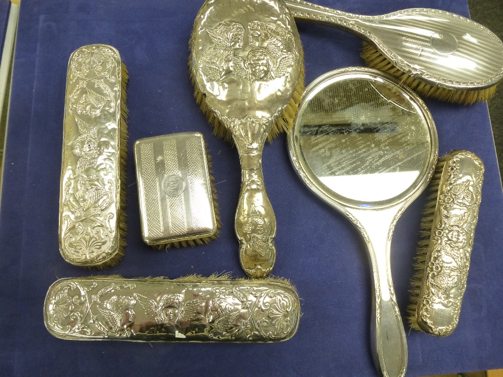 Quantity of silver backed dressing table items including hand mirror, hairbrushes clothes brushes