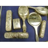 Quantity of silver backed dressing table items including hand mirror, hairbrushes clothes brushes