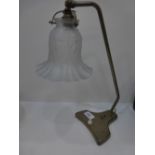 An old brass table lamp having frosted shade