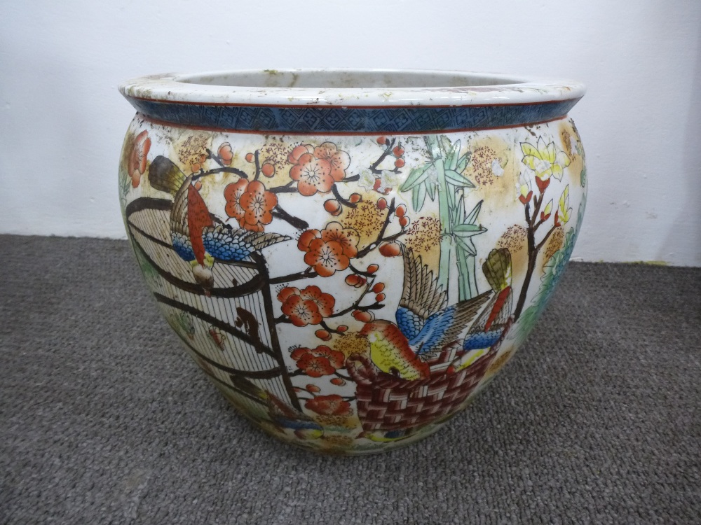 A large Oriental fish bowl decorated birds and trees