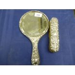 Edwardian Silver backed hand mirror with embossed decoration, Birmingham 1908 and matching clothes