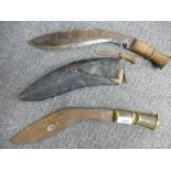 Two old Kukris, one in a sheath