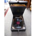 An HMV portable gramaphone in a black resin case