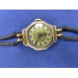 Ladies yellow gold wristwatch with octagonal case, on a black fabric strap