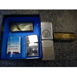 Collection of vintage cigarette lighters including Zippo example