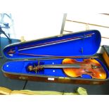 An old Violin, the rear stamped Paganini, 36cms and two bows, on stamped in a Rosewood case