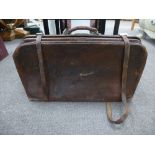 Old leather gladstone bag with external straps