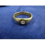 Heavy yellow coloured metal gents ring set with a single diamond, unmarked probably 18ct shank