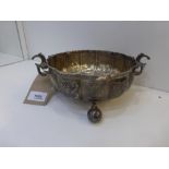 George VI silver bowl with embossed floral decoration, double 'C' scroll handles on 3 ball feet,