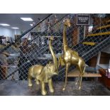 a large brass giraffe and brass elephant