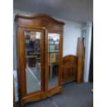 A French Cherrywood armoire with mirrored doors and one long drawer, a similar bedstead and a