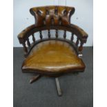 Brown leather buttoned back revolving desk chair