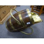 An Old oak and brass bound barrel in the form of a coal scuttle