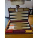 An Asprey 1970's Backgammon set in maroon leather case, size 61cms