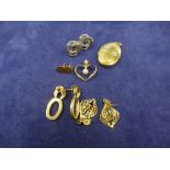 A collection of 9ct yellow and white gold items including oval locket, earrings etc. approx 14g