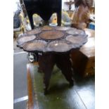A carved occasional table Anglo Indian on a folding base 47cms