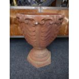 A cast iron style garden urn with acanthus leaf decoration