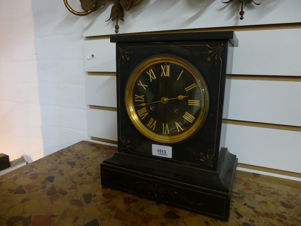 A late Victorian slate mantle clock having gilt decoration with stricking movement