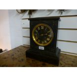 A late Victorian slate mantle clock having gilt decoration with stricking movement