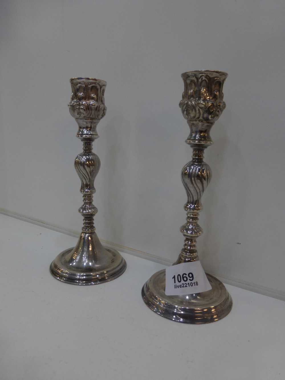 Pair of silver candlicks with turned columns and stepped circular bases, stamped 925, 15.5cm high,