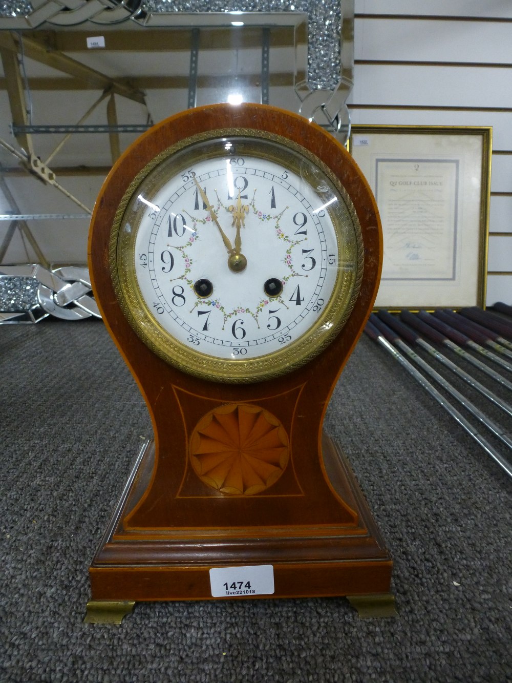 An Edwardian inlaid mahogany balloon clock