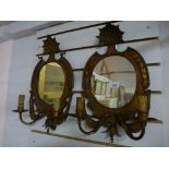 A pair of gilt metal two sconce mirrored wall lights having harebell decoration