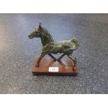 Bronzed model of a horse on a wooden stand